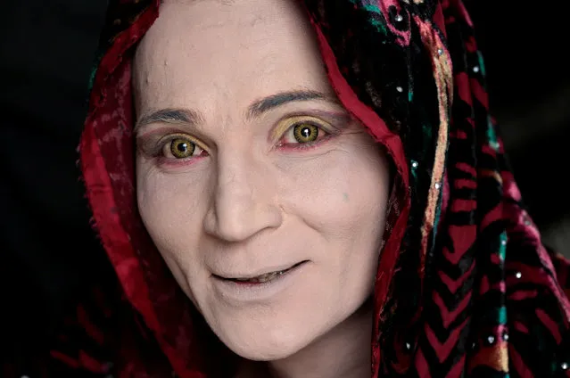 Rani, a member of the transgender community, smiles as she prepares for Shakeela's party in Peshawar, Pakistan January 22,  2017. At a party in Peshawar, the guests' saris twirled as they danced to the music and fed each other pieces of cake, but armed police guarding the door indicated this was no normal carefree birthday gathering. The revellers were transgender, people who run the risk of violence in conservative Muslim Pakistan where they often work as dancers at weddings and other parties but are rarely allowed to hold their own celebrations. (Photo by Caren Firouz/Reuters)