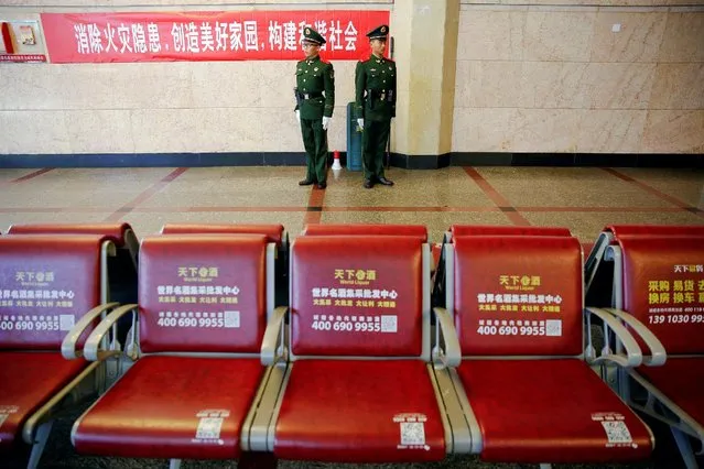 Paramilitary policemen stand guards at the departure hall of the Beijing Railway Station, as China gears up for Lunar New Year, when hundreds of millions of people head home, Beijing, China. January 27, 2017. (Photo by Damir Sagolj/Reuters)