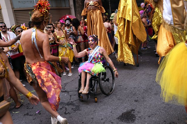 Revelers dance in the “Cordao do Boitata” street pre-carnival party in Rio de Janeiro, Brazil, Sunday, February 4, 2024. (Photo by Silvia Izquierdo/AP Photo)