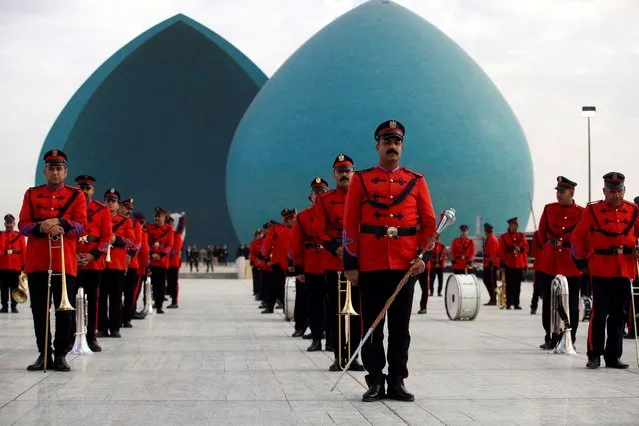 Members of the Iraqi Honor Guard stand at attention during a solemn funeral ceremony for the 41 victims from the Yazidi minority, who were executed by Islamic State (IS) group militants in 2014, at the Al-Shaheed Monument (aka the Martyr's Memorial) in Baghdad, on January 22, 2024. The victims of the August 2014 massacre, carried out in the Sinjar region by IS group militants, have been recently identified through DNA tests. (Photo by Ahmad Al-Rubaye/AFP Photo)