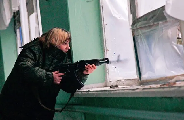 An armed pro-Russian militant holds her position inside of a damaged school in Zaytseve village of Donetsk area, Ukraine, 14 March 2016. Pro-Russian rebels attacked Ukrainian army positions at least 44 times in the past 24 hours, including 38 times in the Donetsk sector, five times in the Mariupol sector and once in the Luhansk sector, the press center of the Anti-Terrorist Operation (ATO) reported. (Photo by Alexander Ermochenko/EPA)