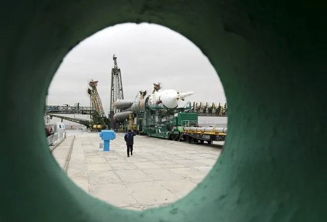 A specialist walks past the Soyuz TMA-20M for the next International Space Station (ISS) crew of Jeff Williams of the U.S. and Oleg Skriprochka and Alexey Ovchinin of Russia as it is transported to the launchpad ahead of its launch scheduled on March 19 at the Baikonur cosmodrome in Kazakhstan March 16, 2016. (Photo by Shamil Zhumatov/Reuters)