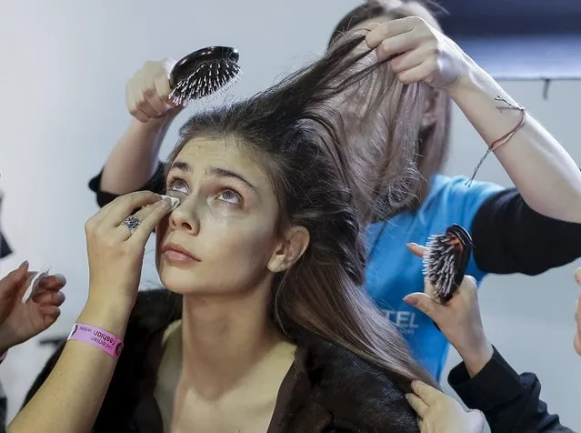 A model has her makeup applied backstage at Ukrainian Fashion Week in Kiev, March 17, 2016. (Photo by Gleb Garanich/Reuters)