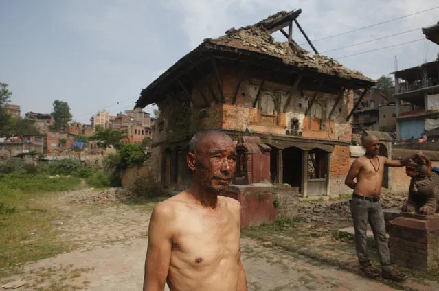 Nepalese people, who lost their family members to the April 25 earthquake, wait to perform rituals to end their mourning period on the banks of Hanumante River in Bhaktapur, Nepal, Wednesday, May 6, 2015. (Photo by Niranjan Shrestha/AP Photo)