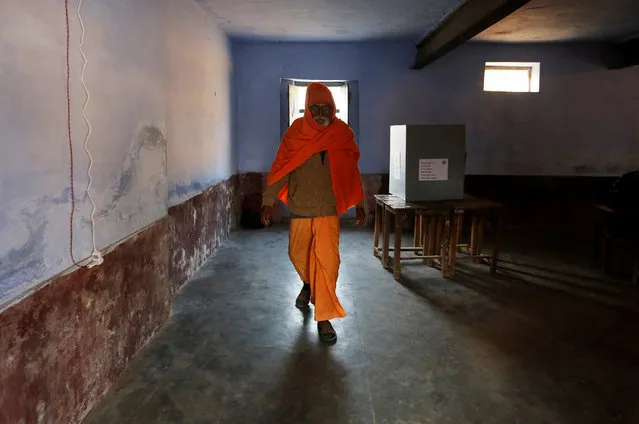 A Sadhu or a Hindu holy man leaves after casting his vote at a polling booth during the state assembly election in Garhmukteshwar, in the central state of Uttar Pradesh, India, February11, 2017. (Photo by Adnan Abidi/Reuters)