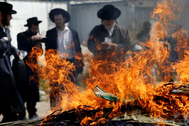 Ultra-Orthodox Jewish men burn leaven in the Mea Shearim neighbourhood of Jerusalem, ahead of the Jewish holiday of Passover, April 3, 2015. Passover commemorates the flight of Jews from ancient Egypt, as described in the Exodus chapter of the Bible. According to the account, the Jews did not have time to prepare leavened bread before fleeing to the promised land. (Photo by Ammar Awad/Reuters)