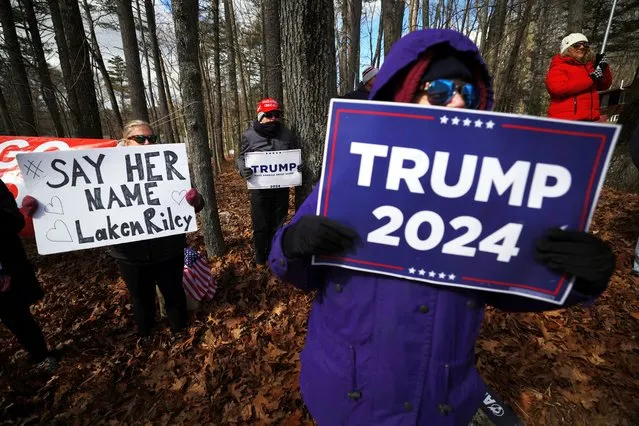 Supporters of Republican presidential candidate, former U.S. President Donald Trump, including one holding a sign reading “Say Her Name Laken Riley”, gather outside a campaign stop by U.S. President Joe Biden in Goffstown, New Hampshire on March 11, 2024. (Photo by Brian Snyder/Reuters)