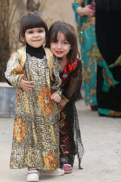Kurdish children wearing traditional clothes pose for a picture during a celebration for Kurdish outfit day in the northeast Syrian Kurdish city of Qamishli٫ Syria March 10, 2016. (Photo by Rodi Said/Reuters)