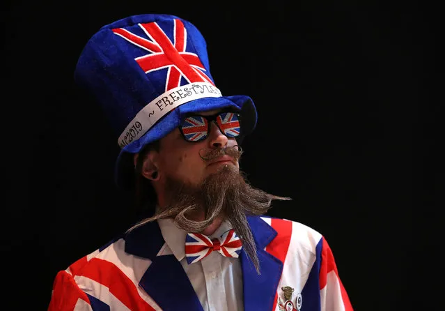 A participant of the international World Beard and Moustache Championships poses before taking part in one of the 17 categories of beard and moustache styles competing in Antwerp, Belgium May 18, 2019. (Photo by Yves Herman/Reuters)
