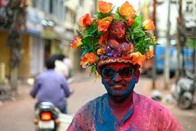A man is smeared with “Gulal” as he celebrates Holi, the Hindu spring festival of colours, in Hyderabad on March 25, 2024. (Photo by Noah Seelam/AFP Photo)