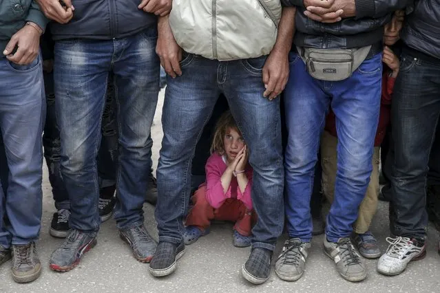 Migrants and refugees gather to listen to Nadia Murad Basee Taha (not pictured), an Iraqi woman of the Yazidi faith who was abducted and held by the Islamic State for three months, at the Greek-Macedonian border near the village of Idomeni, Greece, April 3, 2016. (Photo by Marko Djurica/Reuters)