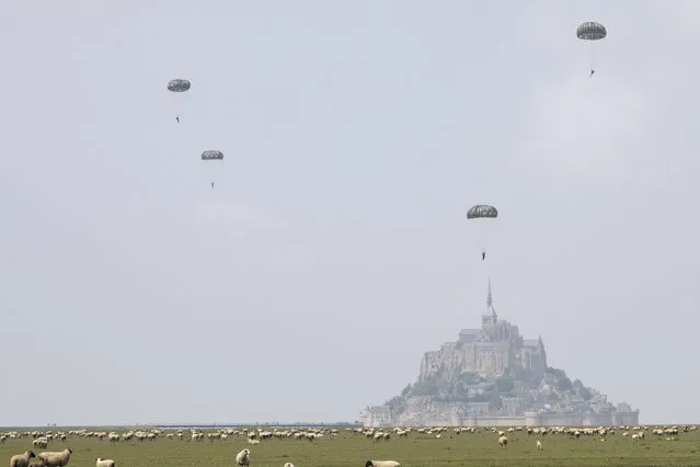 U.S. Army Soldiers assigned to the 10th Special Forces Group (Airborne) conduct an airborne operation near the island of Mont Saint Michel, Avranches Commune, France, May 18, 2019. This event comes at the invitation of the Mayor of Avranches in commemoration of World War II special operations that laid the success for the Allied liberation of France, and a celebration of the strong Alliance between France and the United States. (Photo by Sgt. Avery Cunningham/U.S. Army)