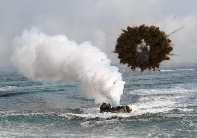 A South Korean marine LVT-7 landing craft sail to shores through a smoke screen during the U.S.-South Korea joint landing exercises called Ssangyong, part of the Foal Eagle military exercises, in Pohang, South Korea, Monday, March 31, 2014. South Korea said North Korea has announced plans to conduct live-fire drills near the rivals' disputed western sea boundary. (Photo by Ahn Young-joon/AP Photo)