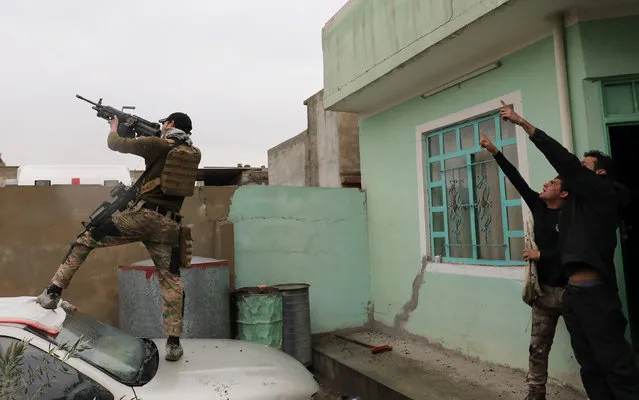 An Iraqi special forces soldier fires at a drone operated by Islamic State militants Islamic State militants in Mosul, Iraq, March 4, 2017. (Photo by Goran Tomasevic/Reuters)