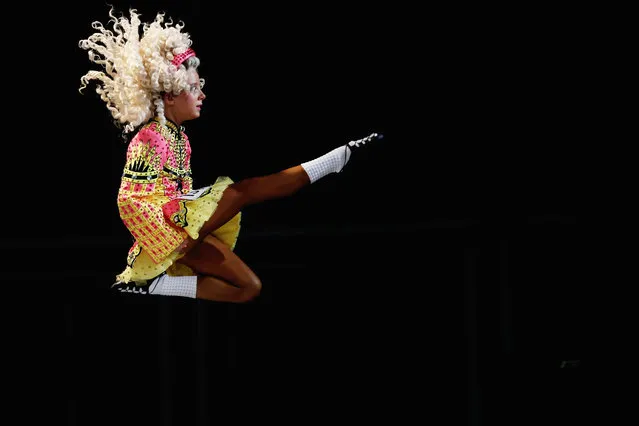 Competitors perform at the World Irish Dance Championship on April 13, 2014 in London, England. The 44th World Irish Dance Championship is currently running at London's Hilton London Metropole hotel, and will host approximately 5,000 dancers competing in solo, Ceili, modern figure choreography and dance drama categories during the week long event. (Photo by Dan Kitwood/Getty Images)