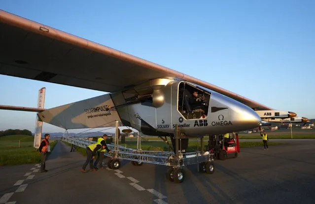 The new Solar Impulse 2 aircraft is pulled out of its base for the first time for tests with solar panels in Payerne April 14, 2014. The aircraft, which was unveiled on April 9, weighs 2.4 tons with a wingspan of 72 meter and more than 17,000 solar cells. The attempt to fly around the world in stages using only solar energy will be made in 2015. (Photo by Denis Balibouse/Reuters)