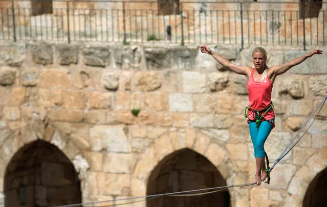 American slackliner Heather Larsen crosses a high wire between two towers at the Tower of David Museum in Jerusalem's Old City May 2, 2016. (Photo by Nir Elias/Reuters)
