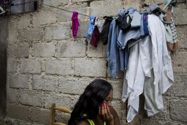 In this August 11, 2016 photo, Lovely Harasme 26, sits in front of her mother's house in Port-au-Prince, Haiti. She says she was one of several women who worked as prostitutes for Sri Lankan peacekeepers with the U.N. (Photo by Dieu Nalio Chery/AP Photo)