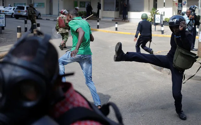 Kenyan policemen beat a protester during clashes in Nairobi, Kenya May 16, 2016. (Photo by Goran Tomasevic/Reuters)