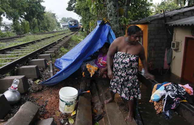 Sri Lankans displaced by the floods take refuge in a temporary shelter next to a railway track in Colombo, Sri Lanka, Tuesday, May 17, 2016. (Photo by Eranga Jayawardena/AP Photo)
