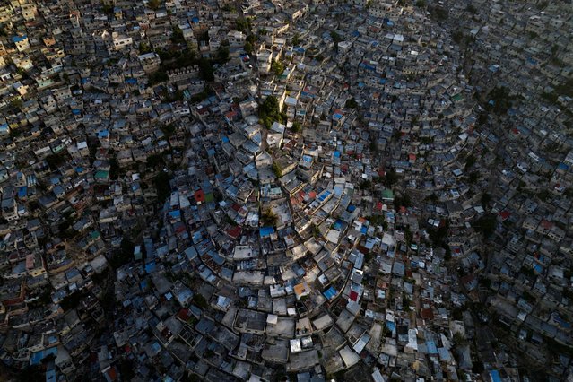 A drone view shows the sun setting over the Jalousie neighborhood, following the arrival of the first contingent of Kenyan police as part of a peacekeeping mission in the Caribbean country, in Port-au-Prince, Haiti on June 30, 2024. (Photo by Ricardo Arduengo/Reuters)