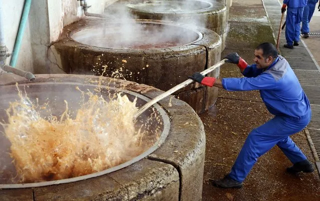 An Iranian worker control the hot water used in dyeing carpet threads at the Zolnavari carpet factory in the city of Shiraz, south western Iran, 21 May 2016. Media reported that Iranian carpet industry seeks revival with lifting the sanctions. Iran's famed carpet weavers are busy at work following the country's historic nuclear deal with world powers, anticipating a boost in exports as sanctions are set to be lifted. Iranian officials expected the Iranian economy to grow on an average of eight percent over the coming five years following the lifting of sanctions against Iran. (Photo by Abedin Taherkenareh/EPA)