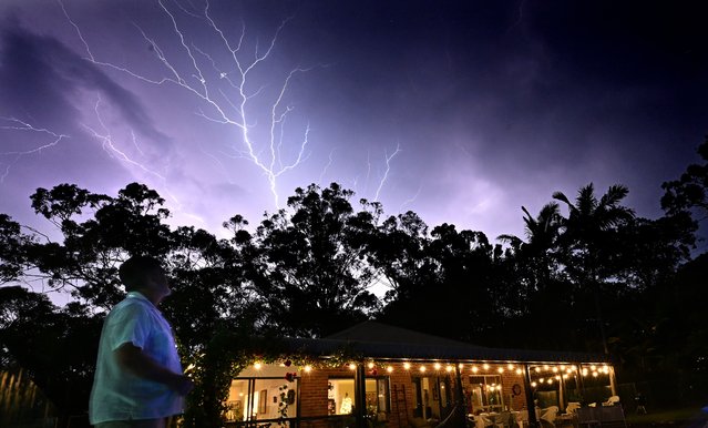 Lightning over Reedy Creek. A woman has died after being struck by a tree after winds of 100km/h lashed the Gold Coast, bringing down trees and power lines in Queensland, Australia on December 25, 2023. (Photo by Dave Hunt/AAP)