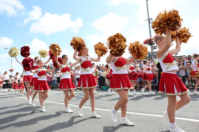 Cheerleaders parade ahead of the Special Sitting of the States of Deliberation of Guernsey’s Parliament during an official visit to Guernsey on July 16, 2024 in St Peter Port, Guernsey. (Photo by Chris Jackson/Getty Images)