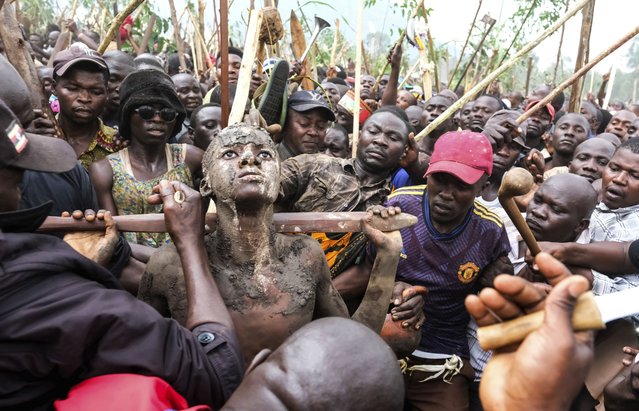 Daniel Wabuyi reacts during his traditional circumcision ritual, known as Imbalu, at Kamu village in Mbale, Eastern Uganda, Saturday, August 3, 2024. (Photo by Hajarah Nalwadda/AP Photo)