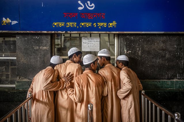 Islamic school boys buy train tickets at the Kamalapur station as passenger railway services resumed in Dhaka on August 13, 2024, days after a student-led uprising that ousted the 15-year rule of ex-premier Sheikh Hasina. Bangladesh was experiencing a "student-led revolution" after the ouster of premier Sheikh Hasina, the South Asian country's new interim leader Muhammad Yunus said. “This is a revolution, a student-led revolution”, the Nobel laureate told a news briefing on August 11. (Photo by Luis Tato/AFP Photo)