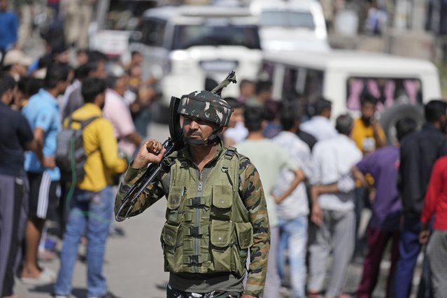 A security officer stands alert near the site of an attack in Jammu, India, Friday, April. 22, 2022. Six suspected rebels and an Indian paramilitary officer were killed in two separate armed clashes in Indian-controlled Kashmir, police said on Friday, two days ahead of Prime Minister Narendra Modi's visit to the disputed region. (Photo by Channi Anand/AP Photo)