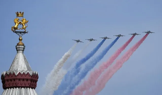 Russian warplanes fly over Red Square leaving trails of smoke in colours of the national flag during a dress rehearsal for the Victory Day military parade in Moscow, Russia, Saturday, May 7, 2022. The parade will take place at Moscow's Red Square on May 9 to celebrate 77 years of the victory in WWII. (Photo by Alexander Zemlianichenko/AP Photo)