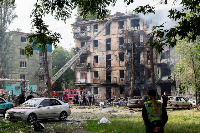 Rescuers work at a site of a residential building heavily damaged by a Russian missile strike, amid Russia's attack on Ukraine, in Kryvyi Rih, Dnipropetrovsk region, Ukraine on June 13, 2023. (Photo by Alina Smutko/Reuters)