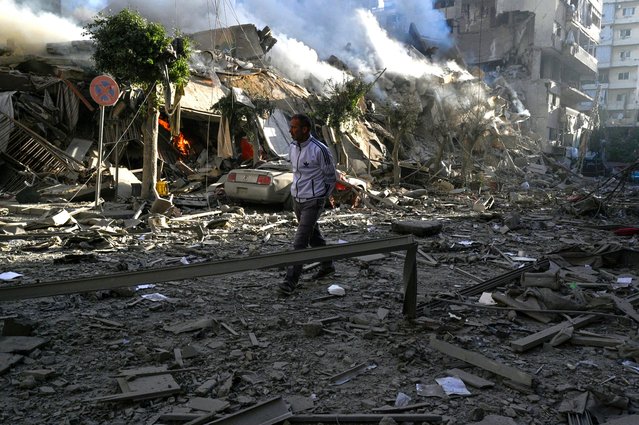 A man walks past damaged buildings following Israeli airstrikes in Dahieh, a southern suburb controlled by Hezbollah in Beirut, Lebanon, 03 October 2024. The Lebanese National News Agency (NNA) said that Israeli airstrikes were carried out overnight in the southern suburb, along with shelling from warships at sea. (Photo by Wael Hamzeh/EPA/EFE)