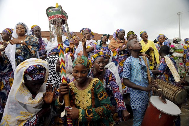 Devotees of the river goddess Osun dance down a street during the traditional town cleansing procession at the start of the annual Osun festival in Osogbo in Nigeria's southwest, August 10, 2015. (Photo by Akintunde Akinleye/Reuters)