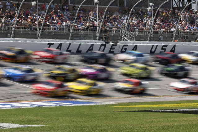 Drivers race down the front stretch three wide during a NASCAR Cup Series auto race at Talladega Superspeedway, Sunday, October 6, 2024, in Talladega, Ala. (Photo by Butch Dill/AP Photo)