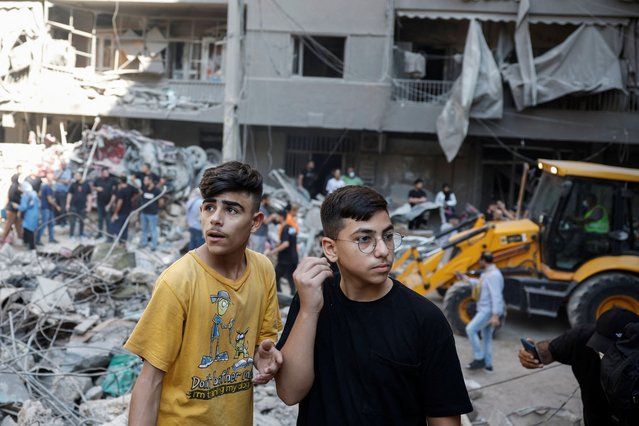 Boys look at the damage at the site of an Israeli air strike, amid ongoing hostilities between Hezbollah and Israeli forces, in Beirut, Lebanon, on October 11, 2024. (Photo by Louisa Gouliamaki/Reuters)