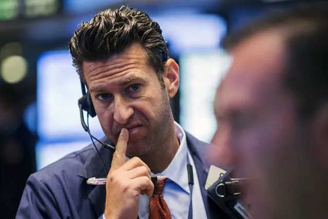 A trader works on the floor of the New York Stock Exchange shortly after the opening bell in New York, August 18, 2015. The Commerce Department report on Tuesday added to solid payrolls, retail sales and industrial output data in suggesting the economy got off to a strong start in the third quarter. The steady flow of upbeat economic reports has bolstered views that the Federal Reserve will raise interest rates in September. (Photo by Lucas Jackson/Reuters)
