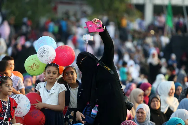 A Palestinian woman takes a selfie during the morning prayers for Eid al-Fitr celebrations, which marks the end of the holy fasting month of Ramadan, in Gaza City July 6, 2016. (Photo by Ibraheem Abu Mustafa/Reuters)