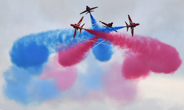 Members of the British Royal Air Force Aerobatic Team, the Red Arrows, perform ahead of the British Formula One Grand Prix at Silverstone motor racing circuit in Silverstone, central England, on July 10, 2016. Lewis Hamilton held his nerve to grab pole position ahead of Mercedes team-mate Nico Rosberg for Sunday's British Grand Prix with a spectacular lap in the final seconds of an intense qualifying session. (Photo by Ben Stansall/AFP Photo)