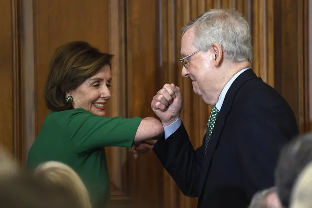 House Speaker Nancy Pelosi of Calif., left, and Senate Majority Leader Mitch McConnell of Ky., right, bump elbows as they attend a lunch with Irish Prime Minister Leo Varadkar on Capitol Hill in Washington, Thursday, March 12, 2020. (Photo by Susan Walsh/AP Photo)