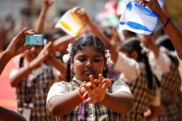 A student demonstrates how to wash hands during an awareness campaign about coronavirus disease (COVID-19), at a school in Chennai, India, March 14, 2020. (Photo by P. Ravikumar/Reuters)