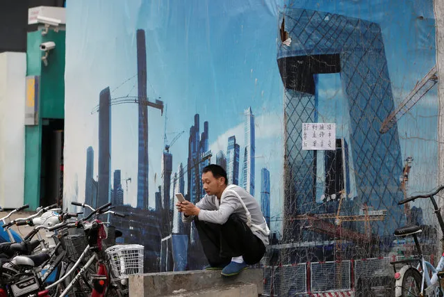 A worker rests outside a construction site in Beijing's central business district, China, July 15, 2016. (Photo by Jason Lee/Reuters)