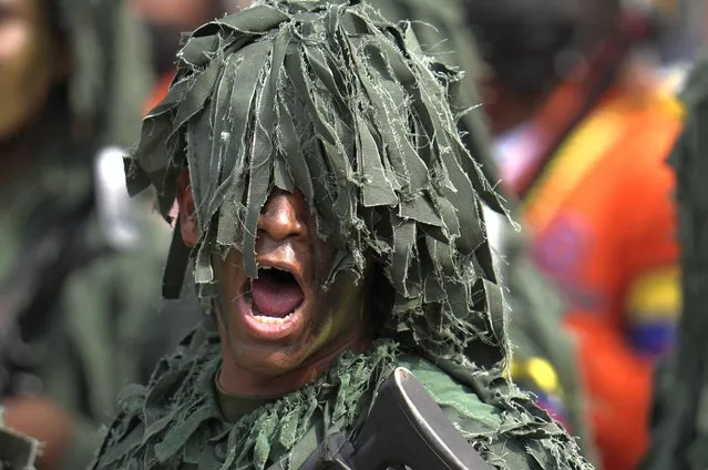 A soldier yells as he marches during the annual Independence Day parade in Caracas, Venezuela, Tuesday, July 5, 2022. Venezuela is marking 211 years of its declaration of independence from Spain. (Photo by Ariana Cubillos/AP Photo)