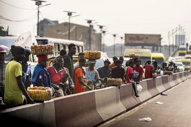 People watch as Secretary of State Antony Blinken's motorcade moves through Kinshasa, Congo, Tuesday, August 9, 2022. (Photo by Andrew Harnik/Pool via AP Photo)