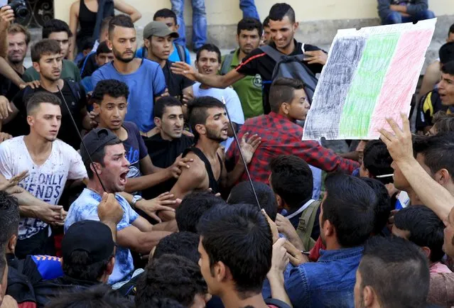 A group of migrants try to make their way through the crowd to the Keleti (Eastern) Railway Terminus in Budapest, Hungary, September 2, 2015. Hundreds of migrants protested in front of the terminus for a second straight day on Wednesday, shouting “Freedom, freedom!” and demanding to be let onto trains bound for Germany from a station that has been closed to them. (Photo by Bernadett Szabo/Reuters)