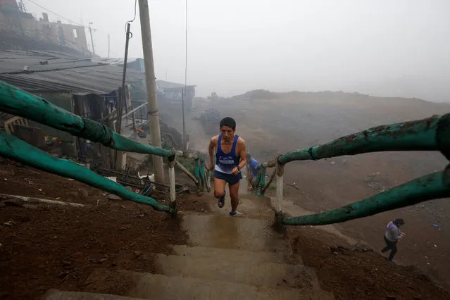 Members of the Tigres de Lima Norte (Tigers of the North of Lima) sport group run as they train in the hills of Carabayllo, one of the poorest neighborhoods in north Lima, Peru, July 16, 2016. Members, mostly of humble backgrounds, train to take part in competitions or to stay in shape. (Photo by Mariana Bazo/Reuters)