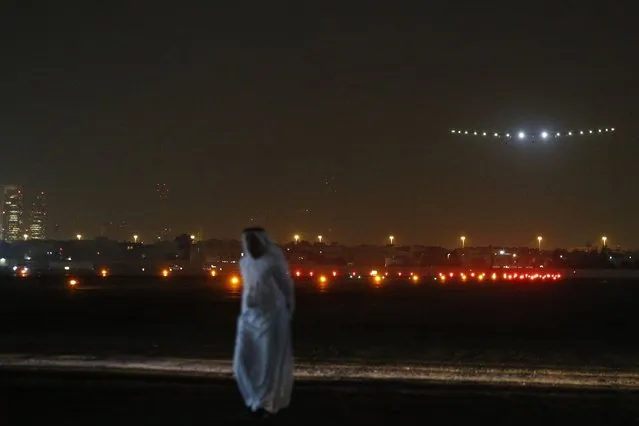 The Solar Impulse 2 aircraft, piloted by Bertrand Piccard, makes its final approach for landing at Al Batin Airport in Abu Dhabi to complete its world tour flight on July 26, 2016 in the United Arab Emirates. Solar Impulse 2 landed July 26 in the UAE, completing its epic journey to become the first sun-powered airplane to circle the globe without a drop of fuel to promote renewable energy. (Photo by Karim Sahib/AFP Photo)