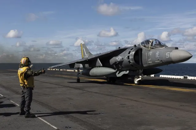 Final checker gives a thumb up to a AV-8B Harrier taking off from the flight deck of the Wasp-class amphibious assault ship USS Kearsarge (LHD 3), operating in the Baltic Sea, Saturday, September 3, 2022. Amid Russia's war on Ukraine and tensions in the Baltic Sea region, USS Kearsarge is the first U.S. Navy amphibious assault ship in at least 20 years to be taking part in international training in the Baltic. (Photo by Michal Dyjuk/AP Photo)