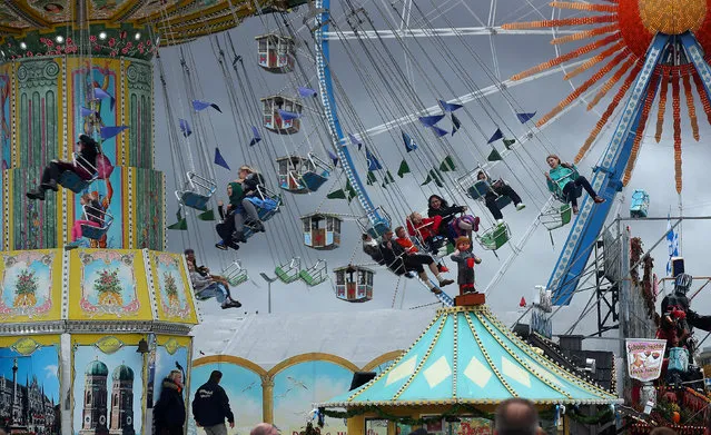 Visitors ride a swing ride during the last day of the 184th Oktoberfest in Munich, Germany, October 3, 2017. (Photo by Michael Dalder/Reuters)